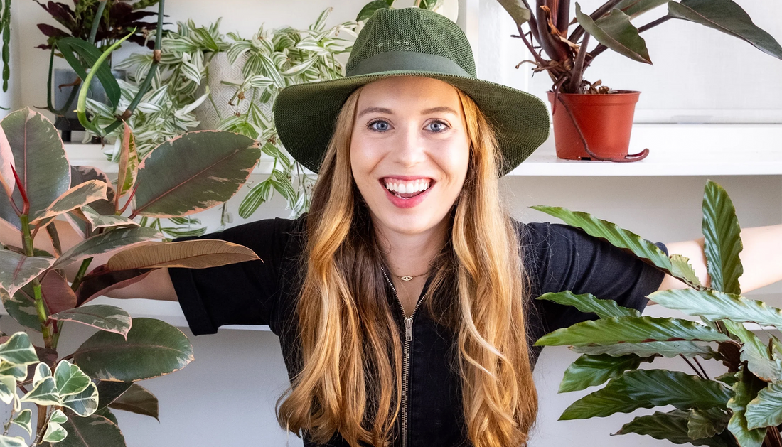 Happy woman sitting with her plants