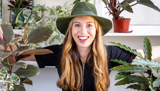 Happy woman sitting with her plants